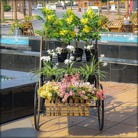 Charming decorative metal bicycle with flower stand adding a rustic touch to your garden.