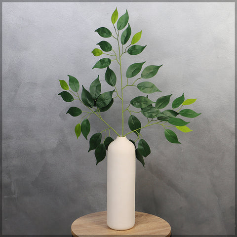 Artificial bamboo leaves in a large vase for modern styling