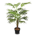 Fake indoor palm with lush leaves in a stylish pot